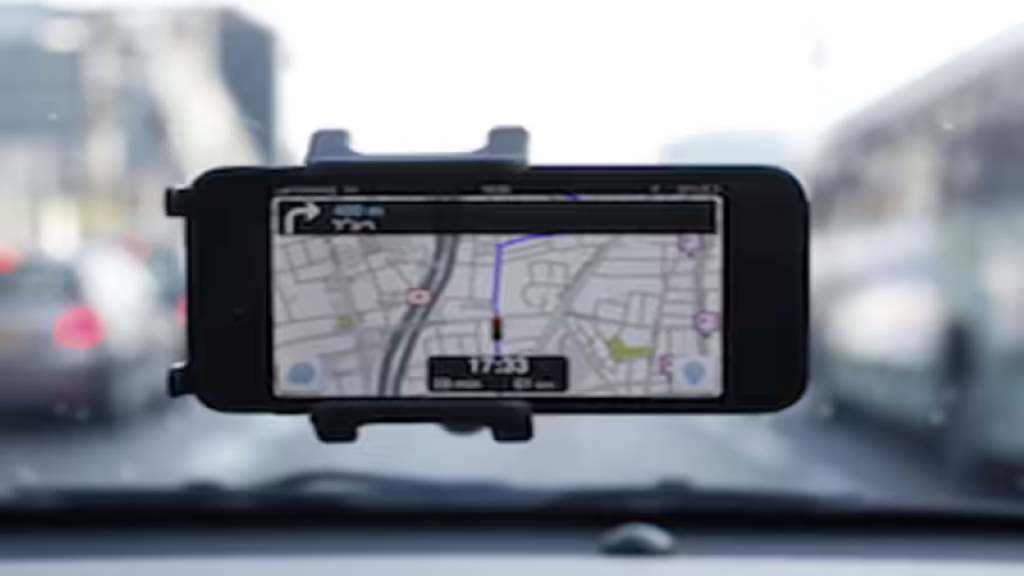 Old smartphone used as a GPS device in a car mount.